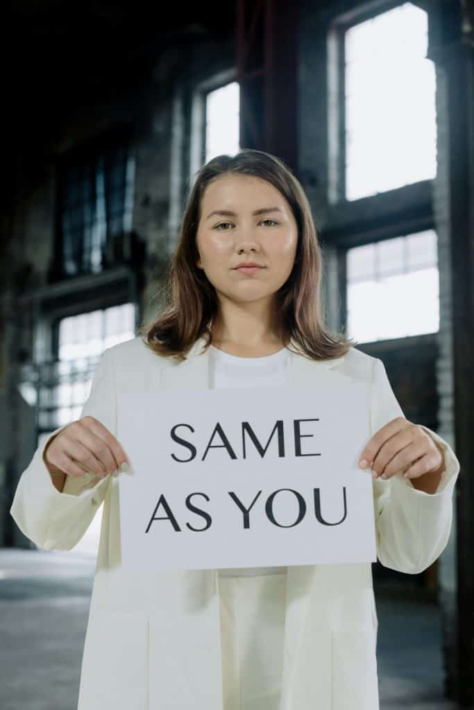 Woman Holding a Paper with Same As You Message