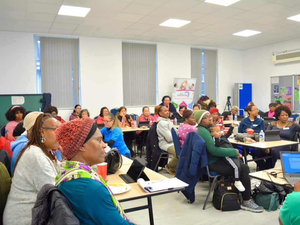 Empowering Communities meeting, the hall is full of people